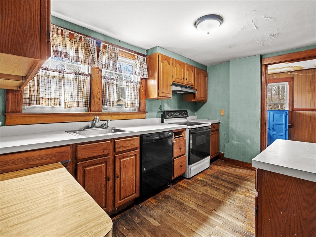 18 Cedar Street Westborough, MA 01581 - Photo 14 of 26 a kitchen with stainless steel appliances granite countertop a stove a sink and a microwave