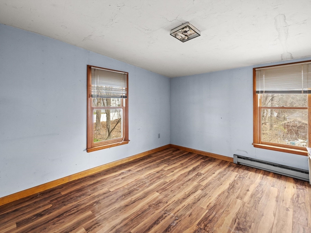18 Cedar Street Westborough, MA 01581 - Photo 20 of 26 a view of an empty room with wooden floor and a window