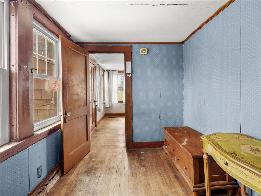 18 Cedar Street Westborough, MA 01581 - Photo 6 of 26 a view of a hallway to a livingroom with wooden floor and furniture