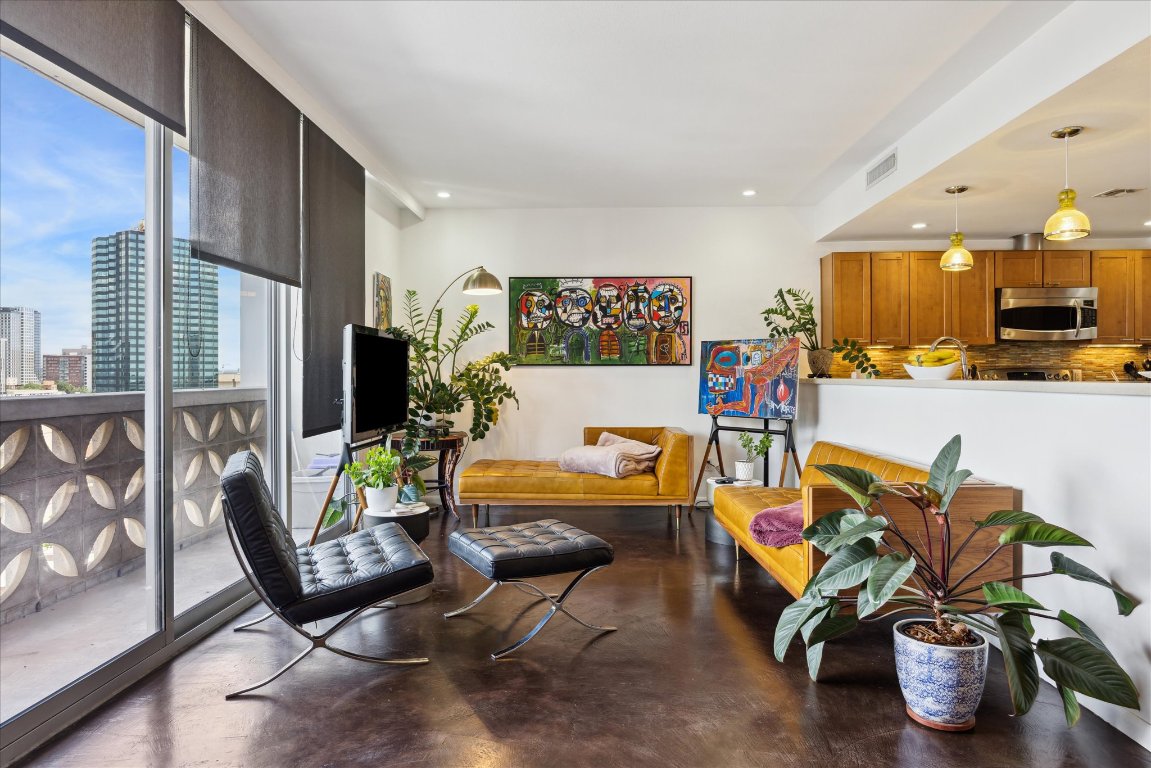 1801 Lavaca Street, Unit 11A Austin, TX 78701 - Photo 2 of 21 a living room with furniture and a flat screen tv