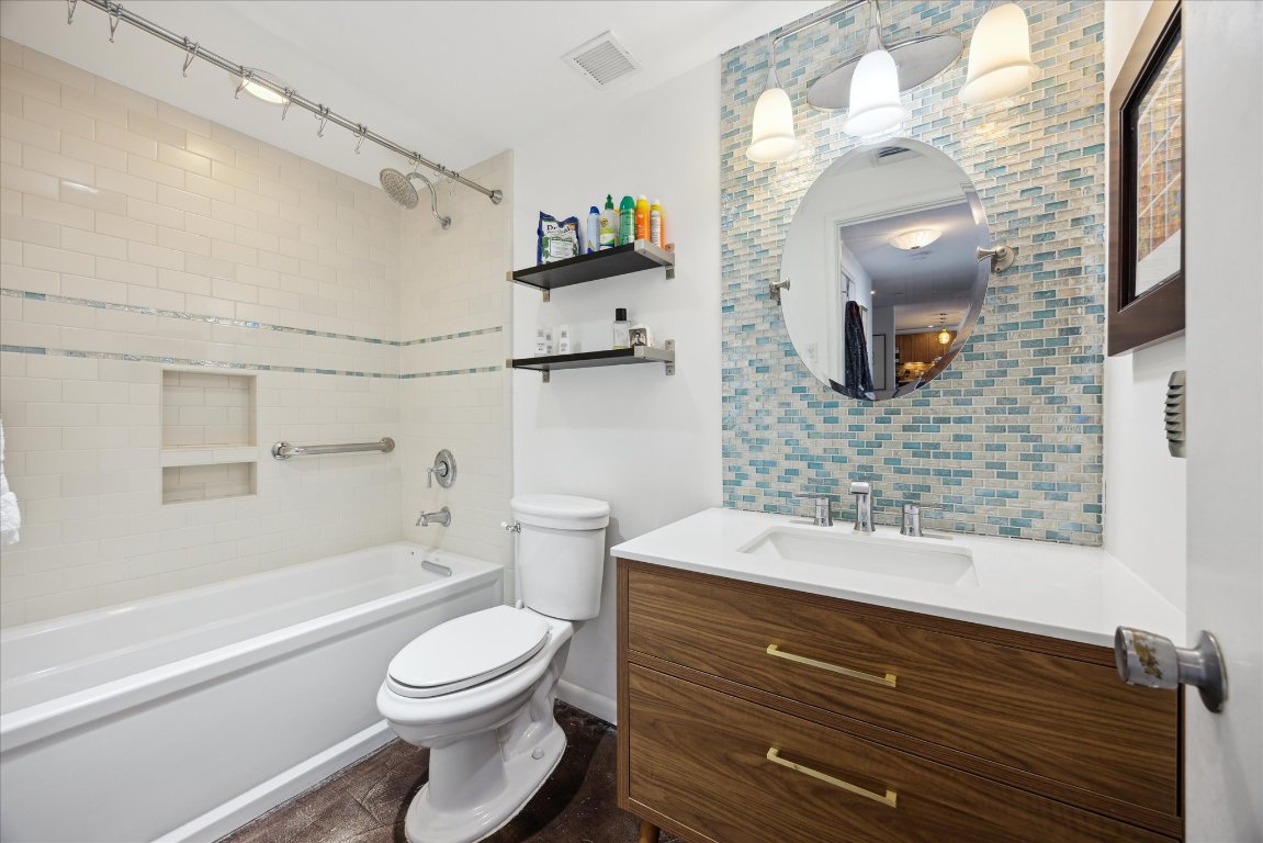 1801 Lavaca Street, Unit 11A Austin, TX 78701 - Photo 8 of 21 a bathroom with a sink a toilet and shower