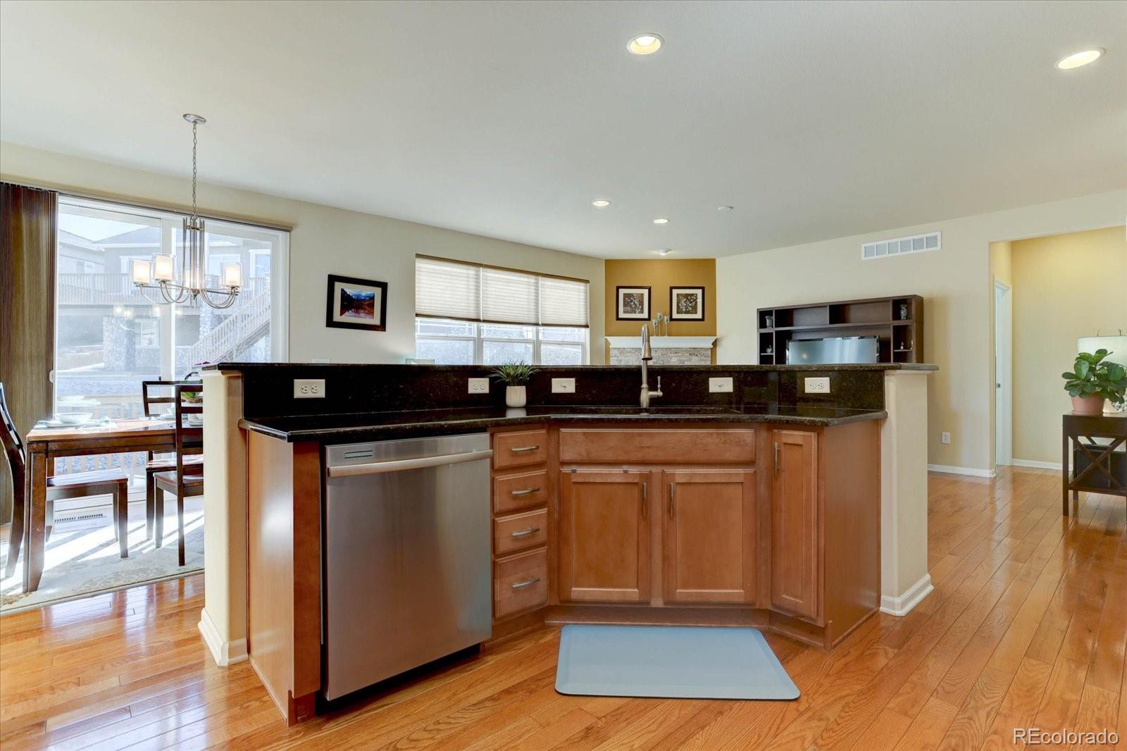 15932 Torreys Way Broomfield, CO 80023 - Photo 10 of 31 a kitchen with stainless steel appliances granite countertop a stove a sink a refrigerator and a microwave