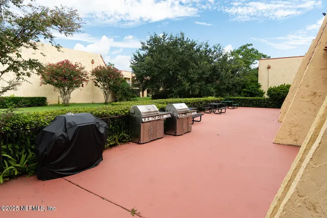 a view of a patio with table and chairs potted plants with sky view