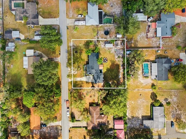 an aerial view of residential houses with outdoor space