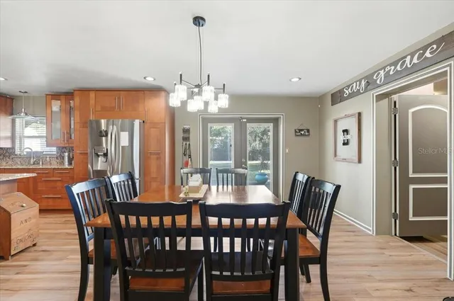 a view of a dining room with furniture wooden floor and chandelier