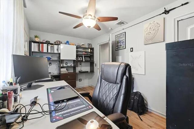 a workspace with furniture and a bookshelf