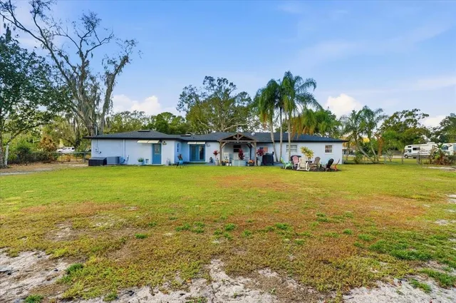 a house view with swimming pool in front of it