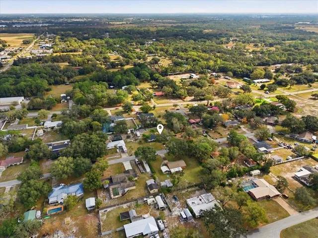 an aerial view of residential houses with city view