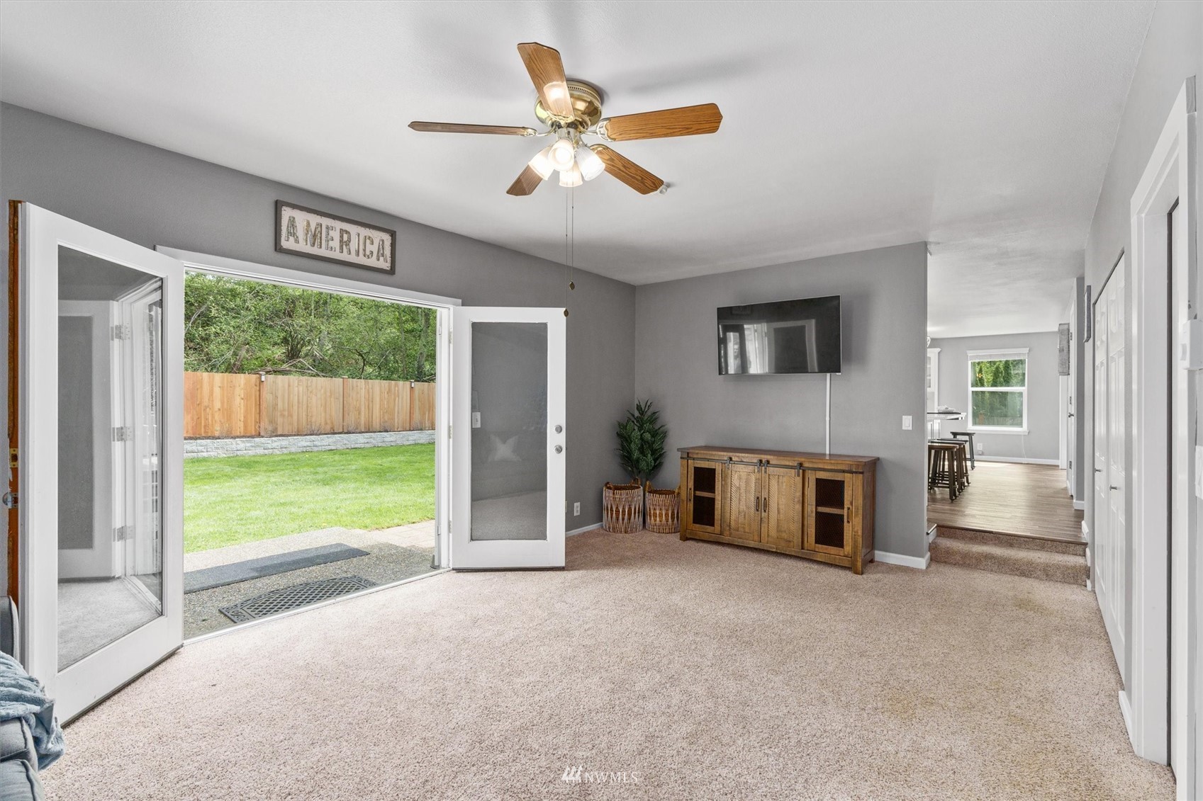 1208 228th Place Southwest Bothell, WA 98021 - Photo 14 of 33 a view of livingroom with furniture hardwood floor and a ceiling fan