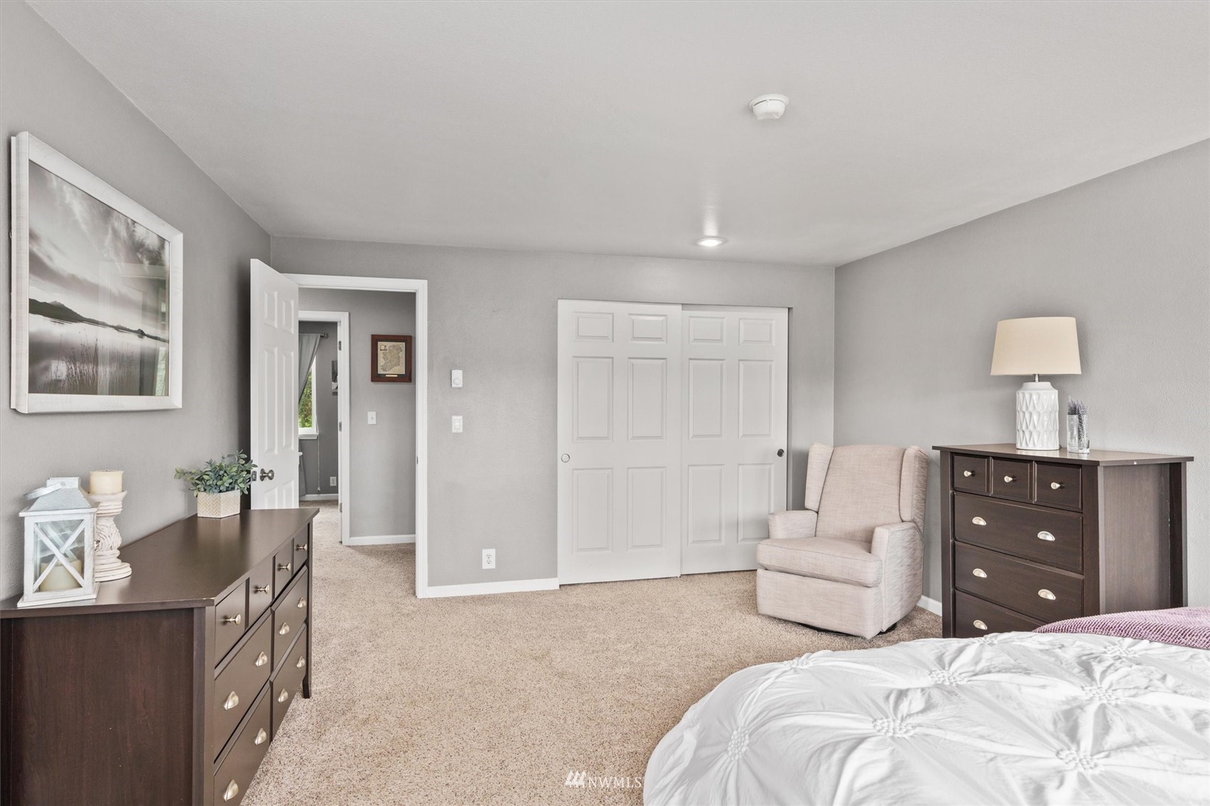 1208 228th Place Southwest Bothell, WA 98021 - Photo 18 of 33 a bedroom with a bed and wooden floor
