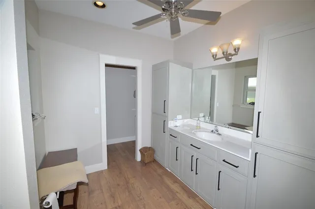 a bathroom with a double vanity sink and a mirror