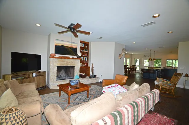 a living room with furniture a flat screen tv and a fireplace
