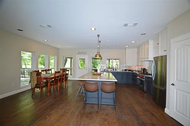 a living room with furniture dining table and wooden floors