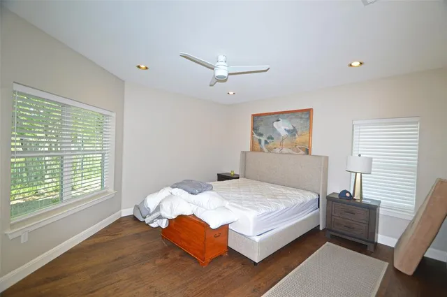 a bedroom with a bed and a large window