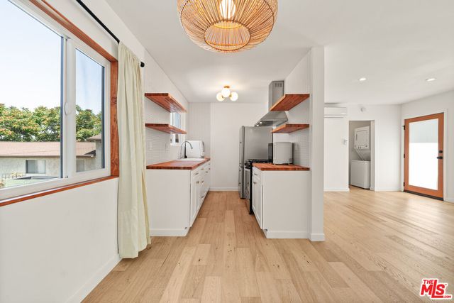 a view of kitchen and hall with wooden floor