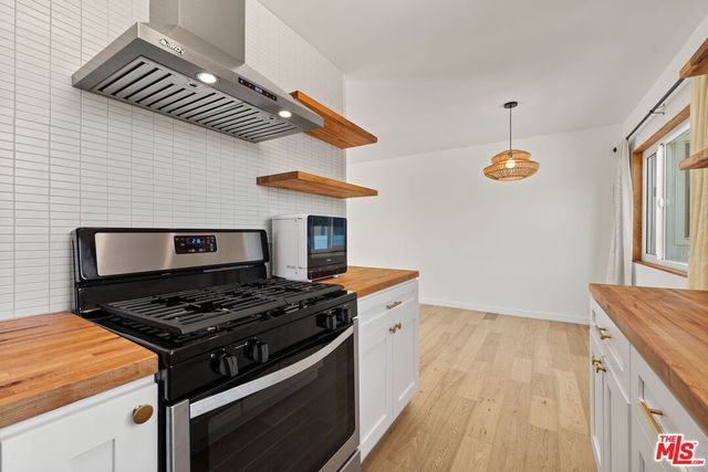 a kitchen with stainless steel appliances granite countertop a stove and a sink