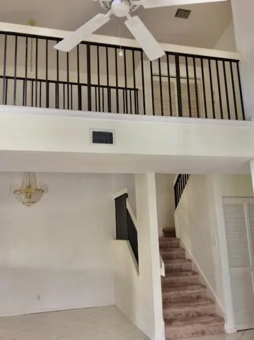 a view of staircase with white walls and a window