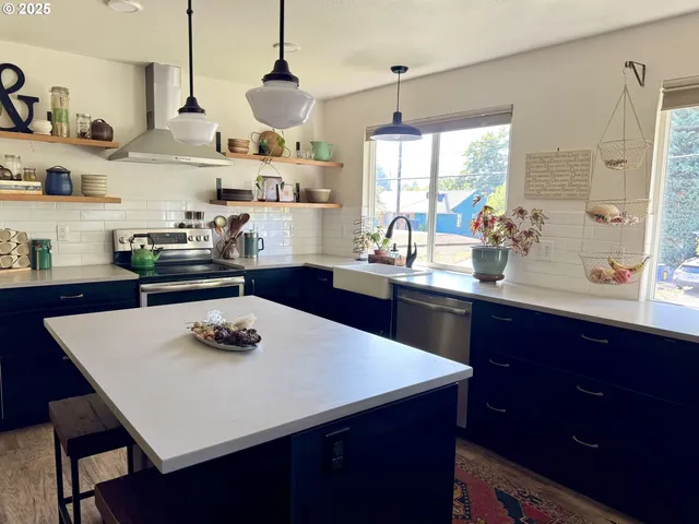 a kitchen with a stove a sink and a refrigerator