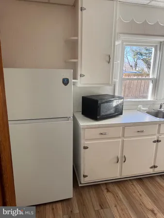a white refrigerator freezer sitting inside of a kitchen