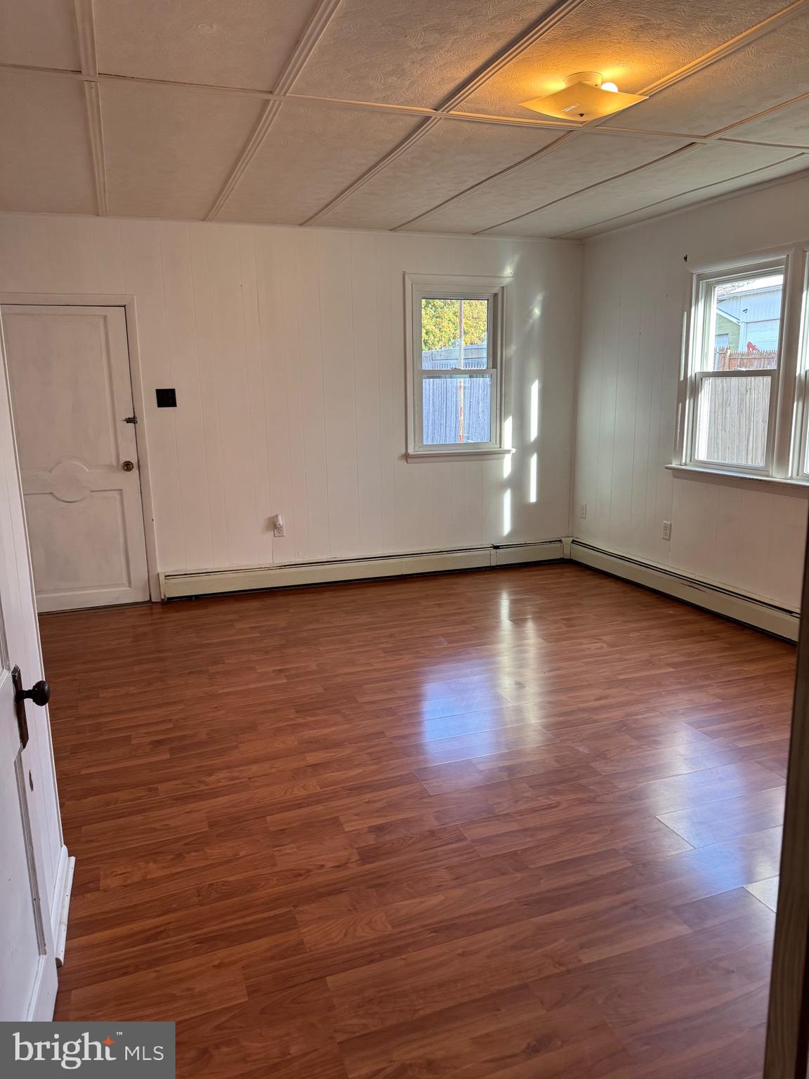 252 West State Street Quarryville, PA 17566 - Photo 5 of 9 a view of an empty room with wooden floor and a window