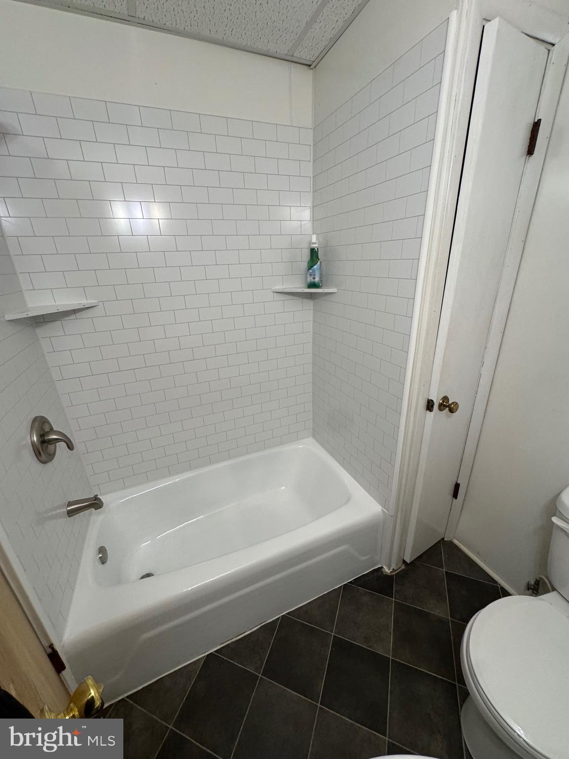 252 West State Street Quarryville, PA 17566 - Photo 7 of 9 a bathroom with a bathtub and a toilet