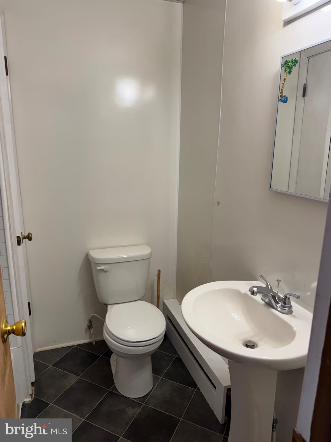 252 West State Street Quarryville, PA 17566 - Photo 8 of 9 a white toilet sitting next to a bathroom sink