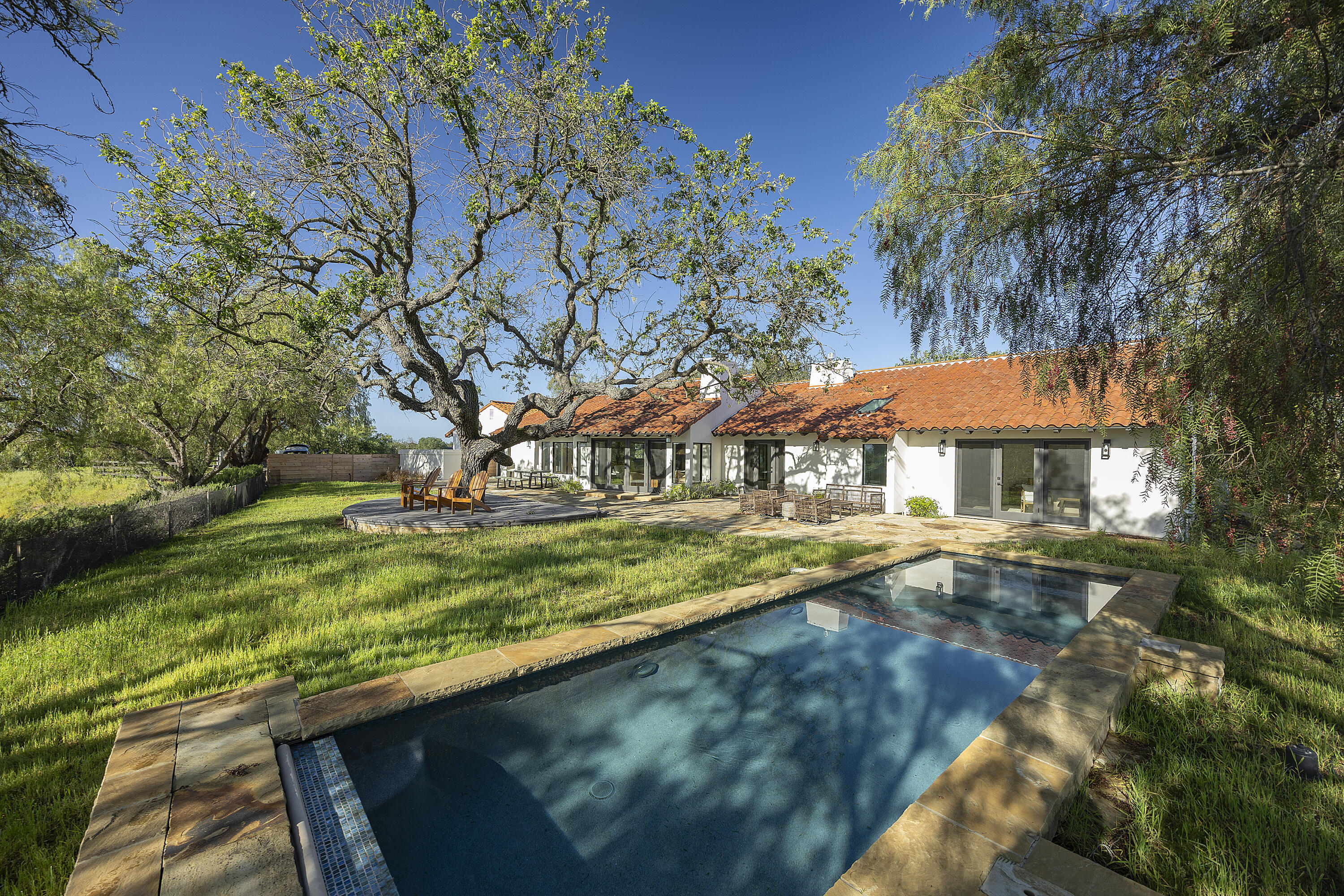 3009 Woodstock Road Santa Ynez, CA 93460 - Photo 1 of 32 a view of swimming pool with lawn chairs under an umbrella