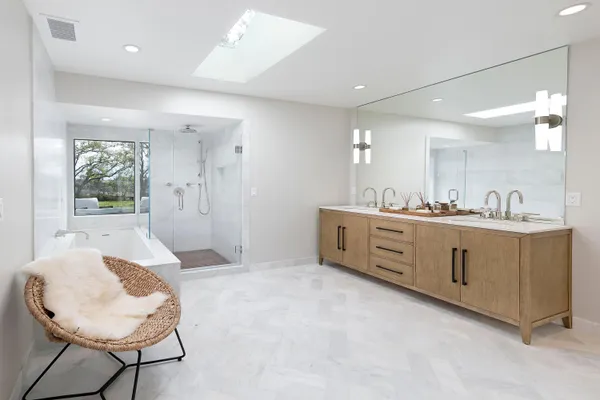 a spacious bedroom with a bed and a large window