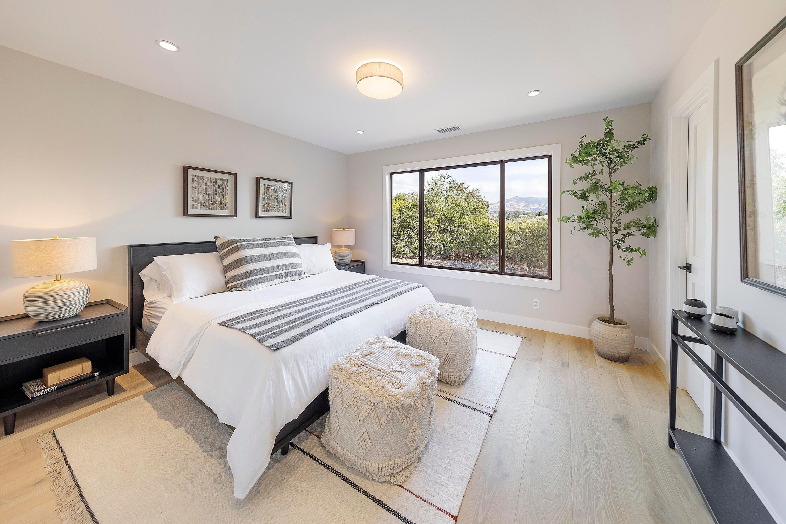 3009 Woodstock Road Santa Ynez, CA 93460 - Photo 19 of 32 a spacious bedroom with a bed and a large window
