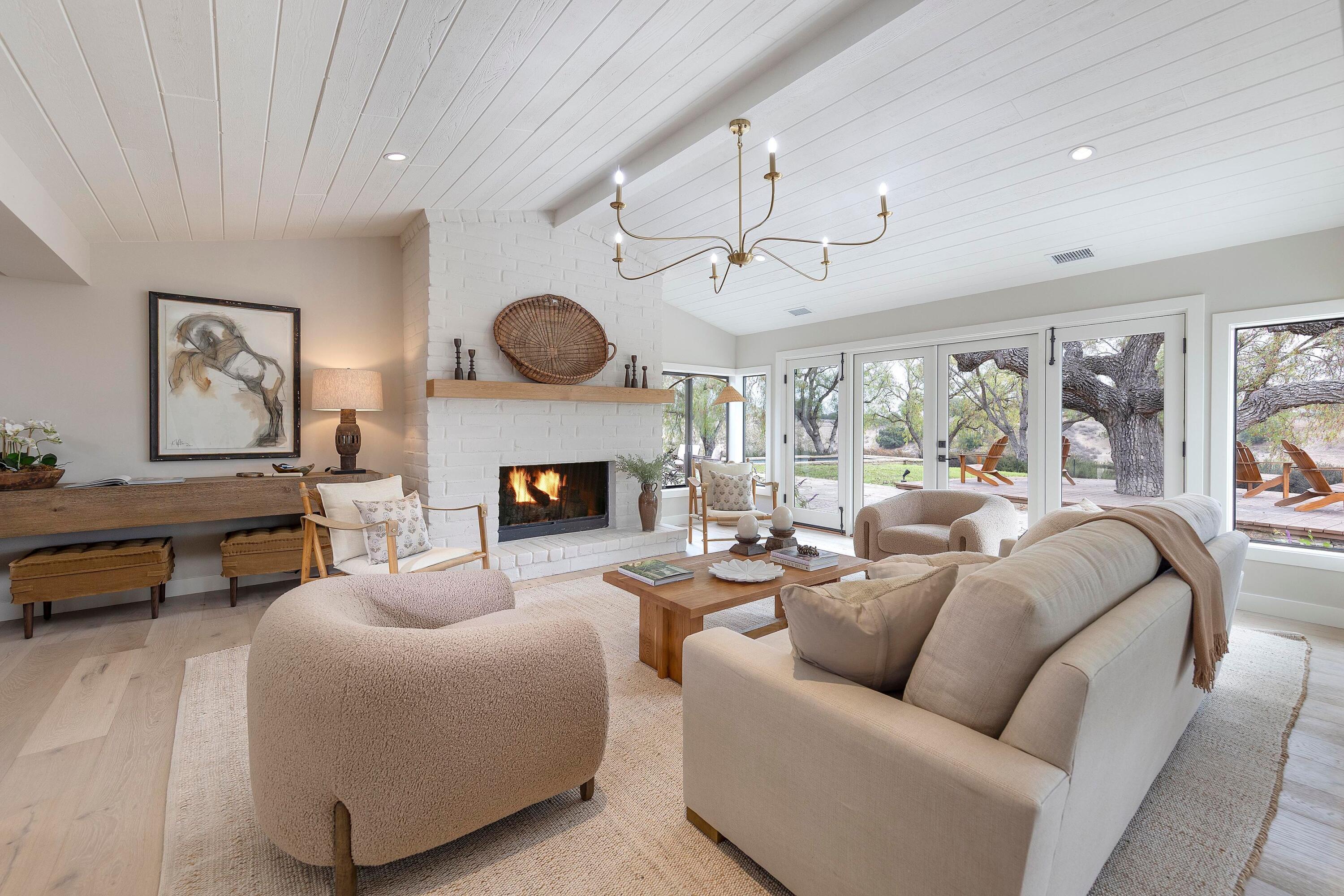 3009 Woodstock Road Santa Ynez, CA 93460 - Photo 25 of 32 a living room with furniture a fireplace and a large window