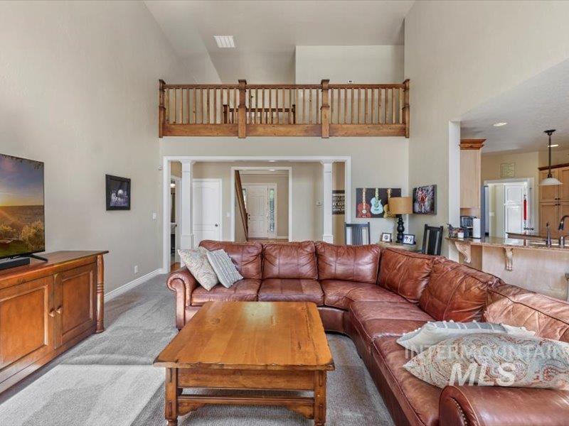 3408 Ridge Line Drive Kimberly, ID 83341 - Photo 13 of 37 Living room with high vaulted ceiling and light colored carpet