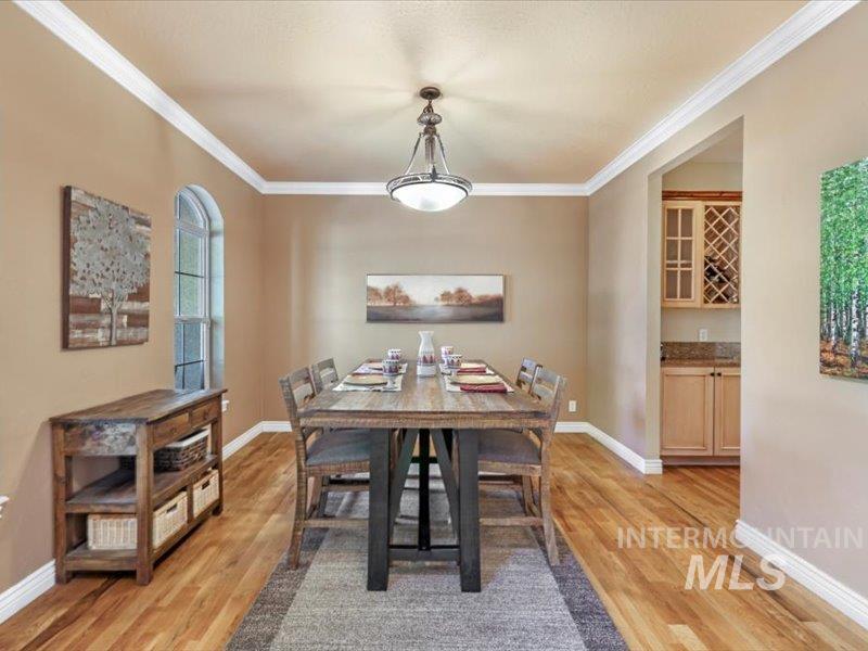 3408 Ridge Line Drive Kimberly, ID 83341 - Photo 14 of 37 Dining space with light wood-style flooring, ornamental molding, and bar