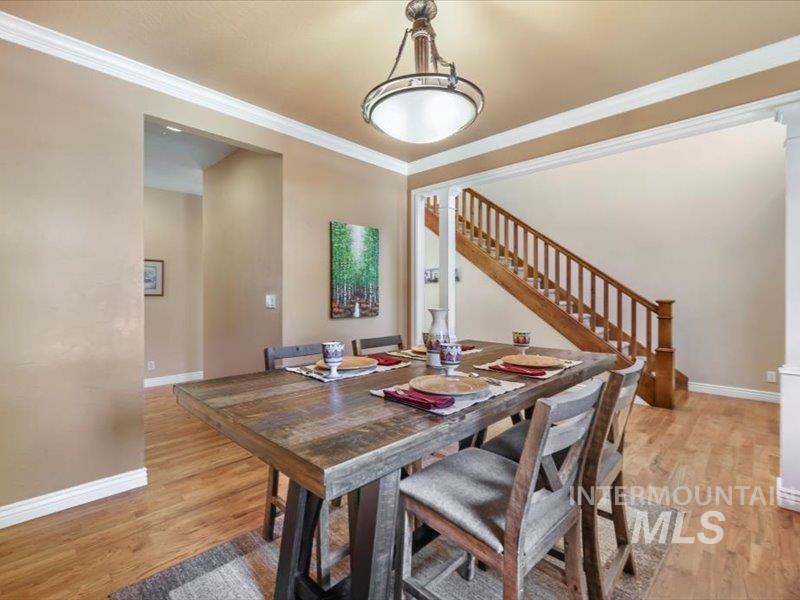 3408 Ridge Line Drive Kimberly, ID 83341 - Photo 16 of 37 Dining area featuring stairway, light wood-type flooring, crown molding, and ornate columns