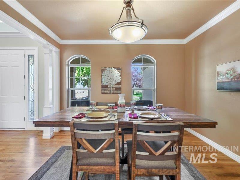 3408 Ridge Line Drive Kimberly, ID 83341 - Photo 17 of 37 Dining room featuring wood finished floors, ornamental molding, and ornate columns