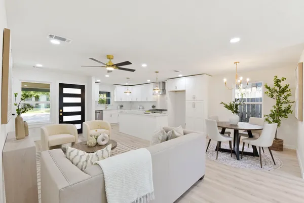 a living room with furniture and kitchen view