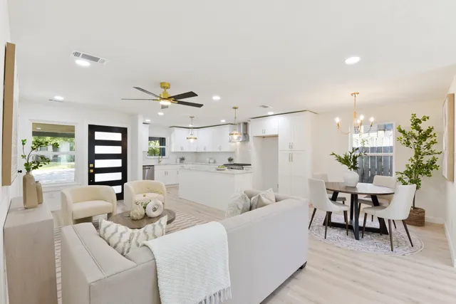 a living room with furniture and kitchen view