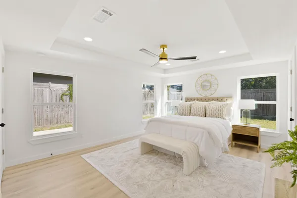 a bedroom with a bed and a chandelier