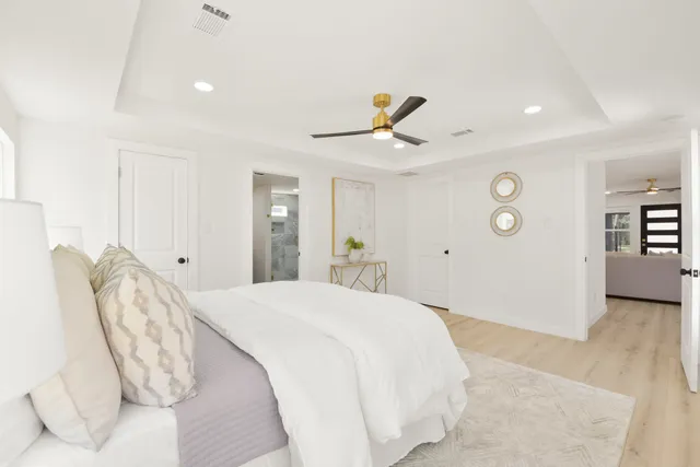 a bedroom with a bed and a chandelier