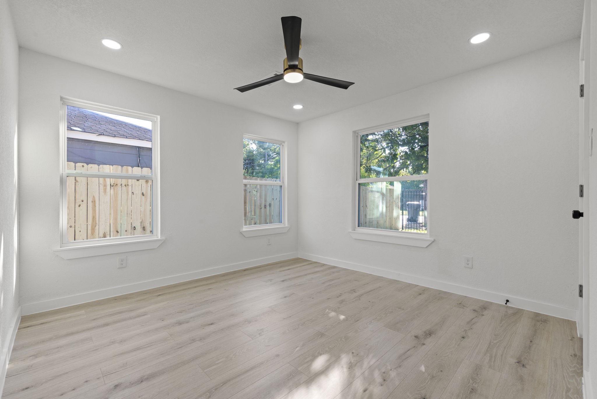 1630 1/2 Tabor Street Houston, TX 77009 - Photo 21 of 28 a view of an empty room with a window and wooden floor