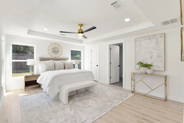 a bedroom with a bed and a chandelier