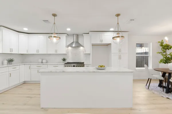 a kitchen with sink stove and cabinets