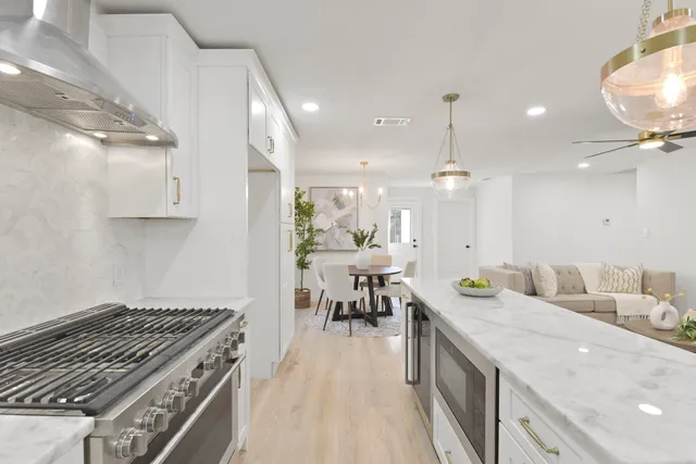 a kitchen with sink stove and cabinets