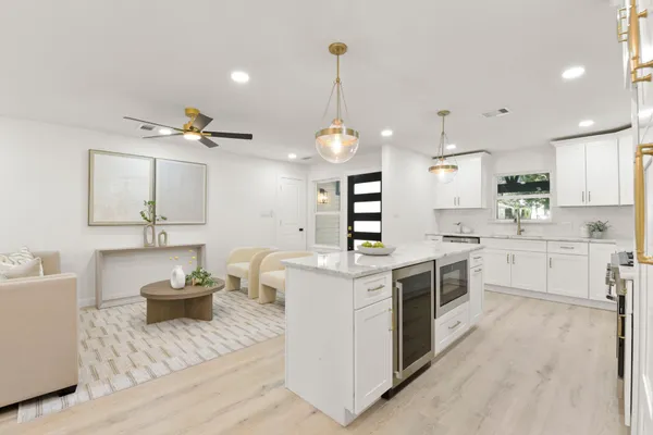 a kitchen with a potted plant on the counter and cabinets