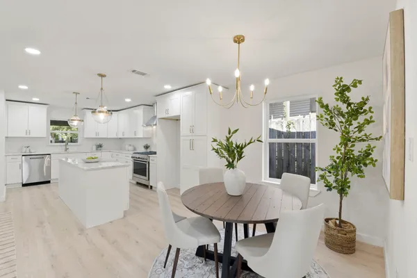 a view of a dining room with furniture and wooden floor