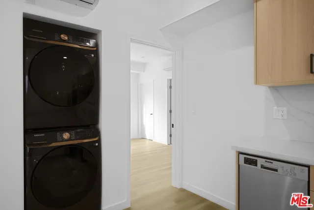 a view of a hallway with washer and dryer