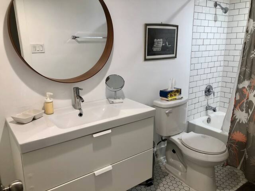 5909 Bolm Road, Unit 12 Austin, TX 78721 - Photo 2 of 15 Bathroom featuring shower / bathtub combination with curtain, vanity, and tile patterned flooring