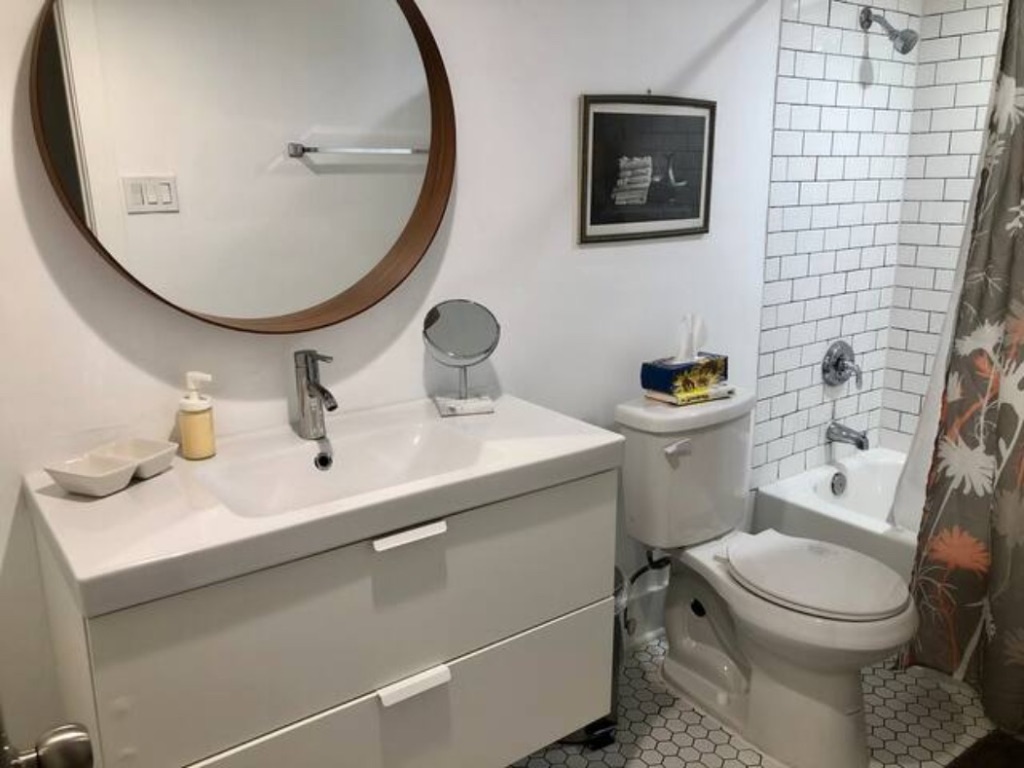 5909 Bolm Road, Unit 12 Austin, TX 78721 - Photo 2 of 15 a bathroom with a toilet a sink and mirror