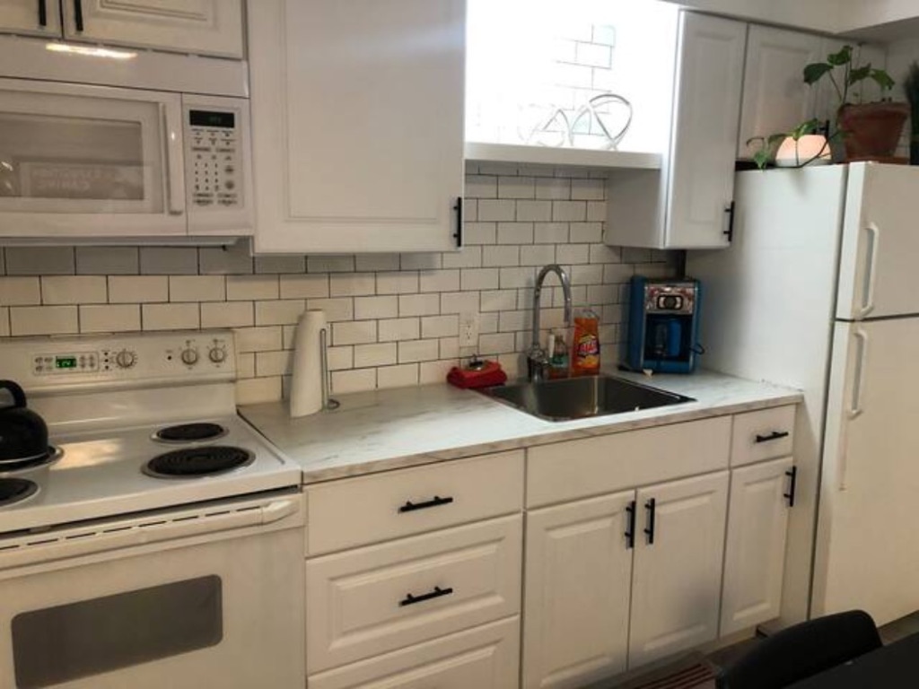 5909 Bolm Road, Unit 12 Austin, TX 78721 - Photo 8 of 15 a kitchen with a white cabinets and white appliances