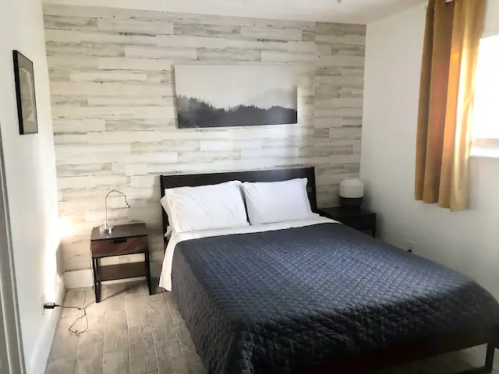 5909 Bolm Road, Unit 12 Austin, TX 78721 - Photo 9 of 15 a bedroom with a bed and a painting on the wall