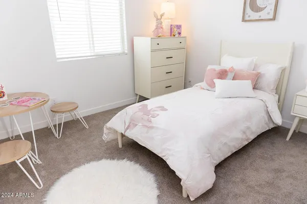 a bedroom with a bed and chair